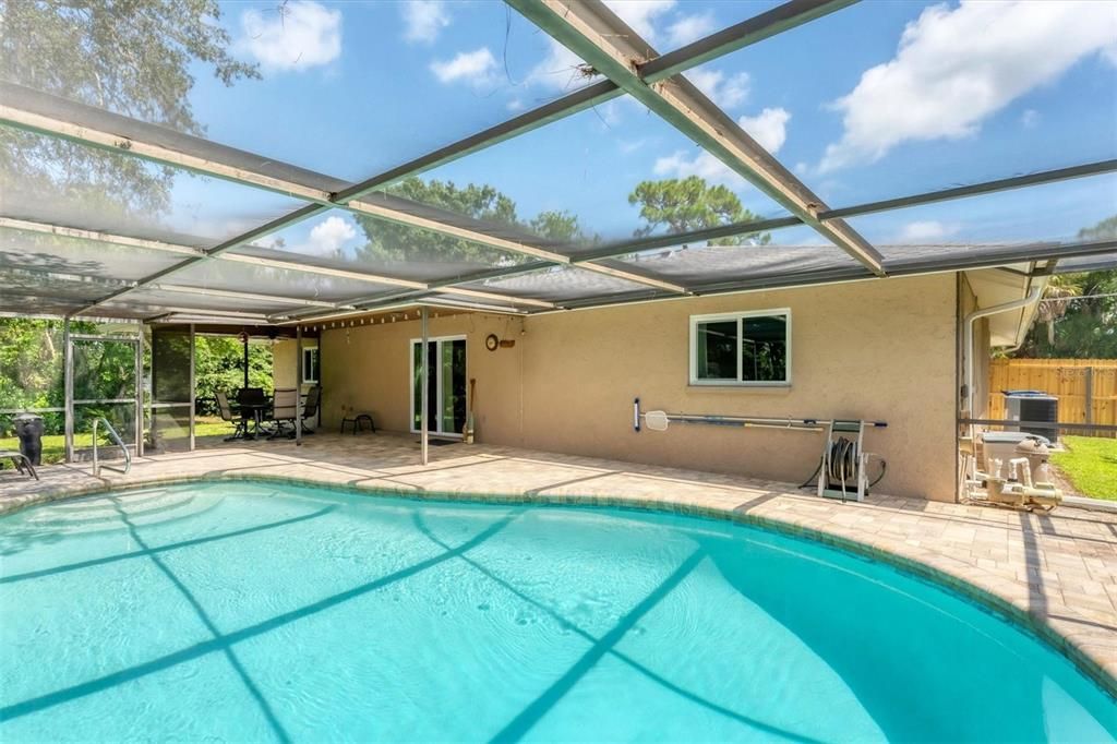 Screen enclosed lanai with paver pool deck