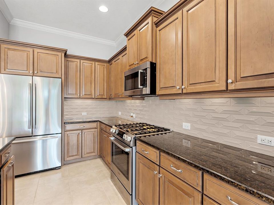 Granite countertops and tile backsplash walls