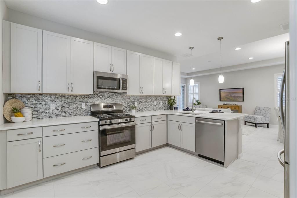 Kitchen w/ 42" wood cabinets, Pot/Pan drawers & Listello tile backsplash