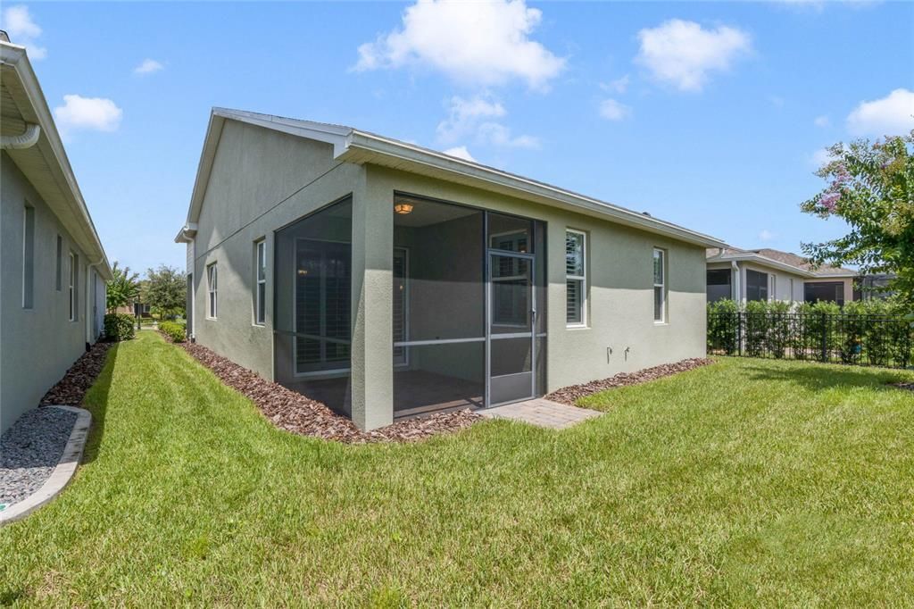 View of rear of home & screen enclosed covered lanai