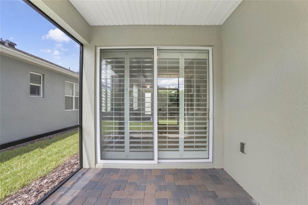 View of the sliding Plantation style shutters for the glass doors leading to Great Room area