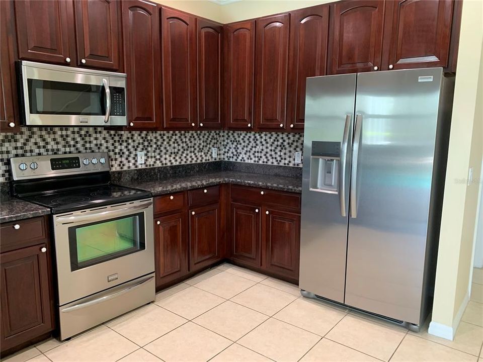 Kitchen with refrig, oven and microwave