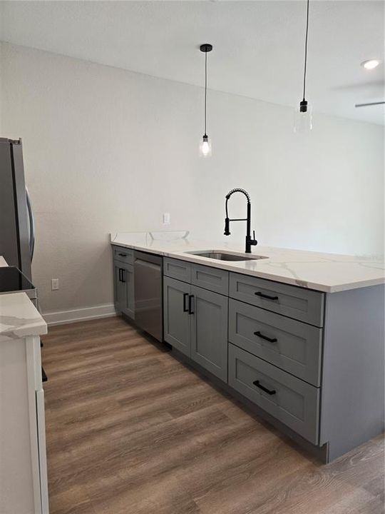 island in kitchen with nice counter space and cabinets