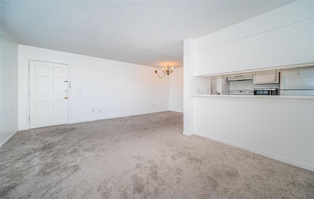 A spacious living room with an open floorplan, seamlessly connecting to the kitchen and dining area for easy flow and entertaining.