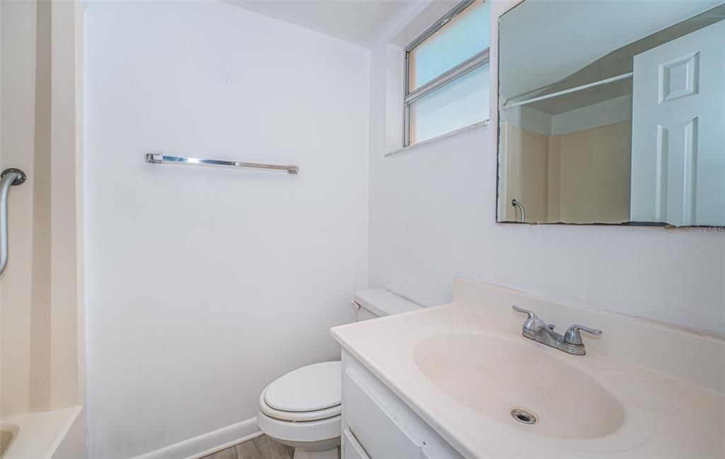 Enjoy the convenience of this primary bathroom, equipped with a sink, a tub with shower, and thoughtful accessibility features to ensure comfort and ease of use.