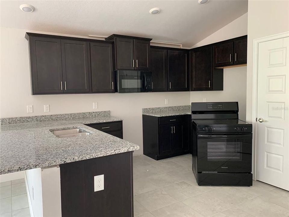 GRANITE w/wood cabinets