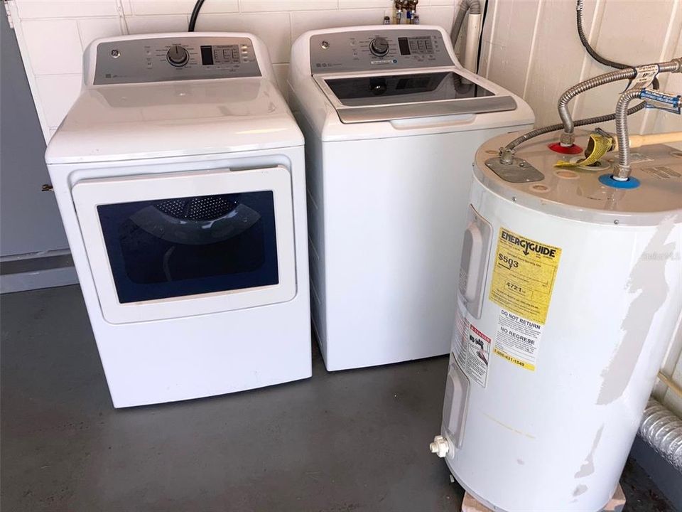 Washer and dryer, water heater in garage.