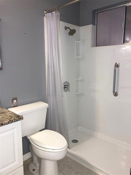 Bathroom with step in shower.