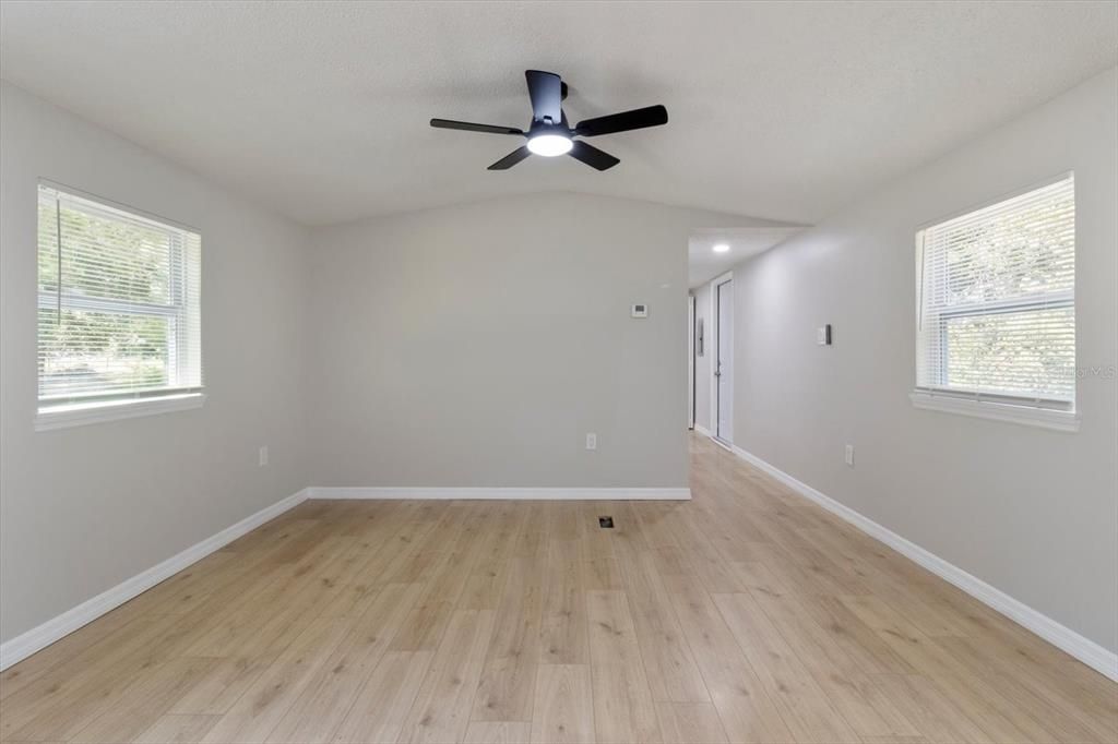 Living Room...Freshly Painted Interior w/ NEW Ceiling Fans, Blinds & Luxury Vinyl Planking Thoroughout