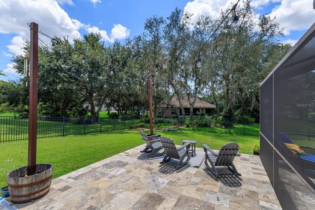 Travertine paver patio with barrel lights