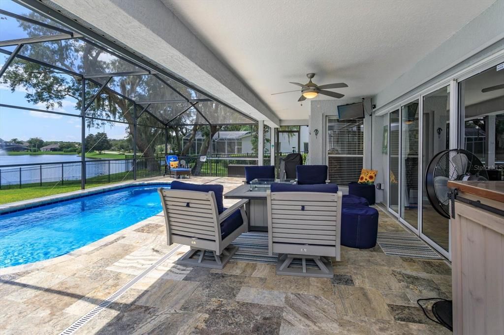 Travertine covered porch and pool with expansive views