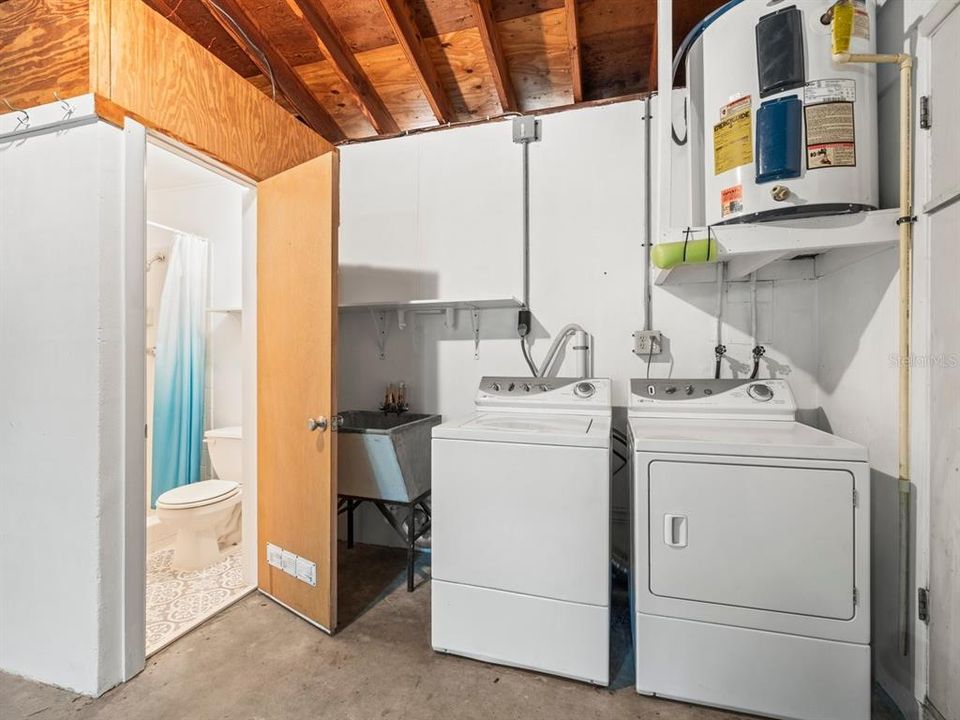 Convenient laundry area with half bath in garage.