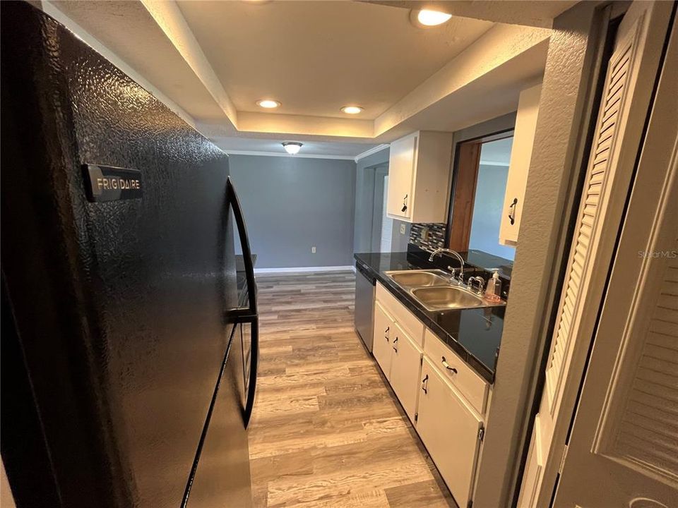 Galley style Kitchen with tile counter tops and a pantry