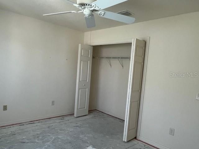 Guest Bedroom w/closet - Exposed concrete flooring