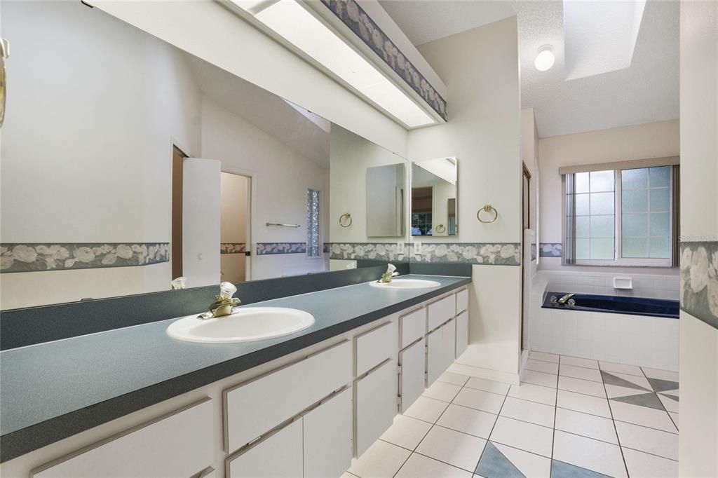 Dual sinks, under cabinet lighting, garden soaking tub, separate shower, private privy, walk-in closet