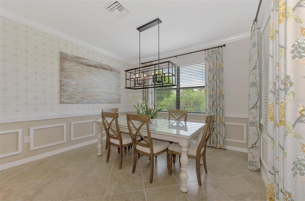 The home's large windows provide for a lot of natural light.  You can see the architectural detail found throughout the home evident in the dining room.