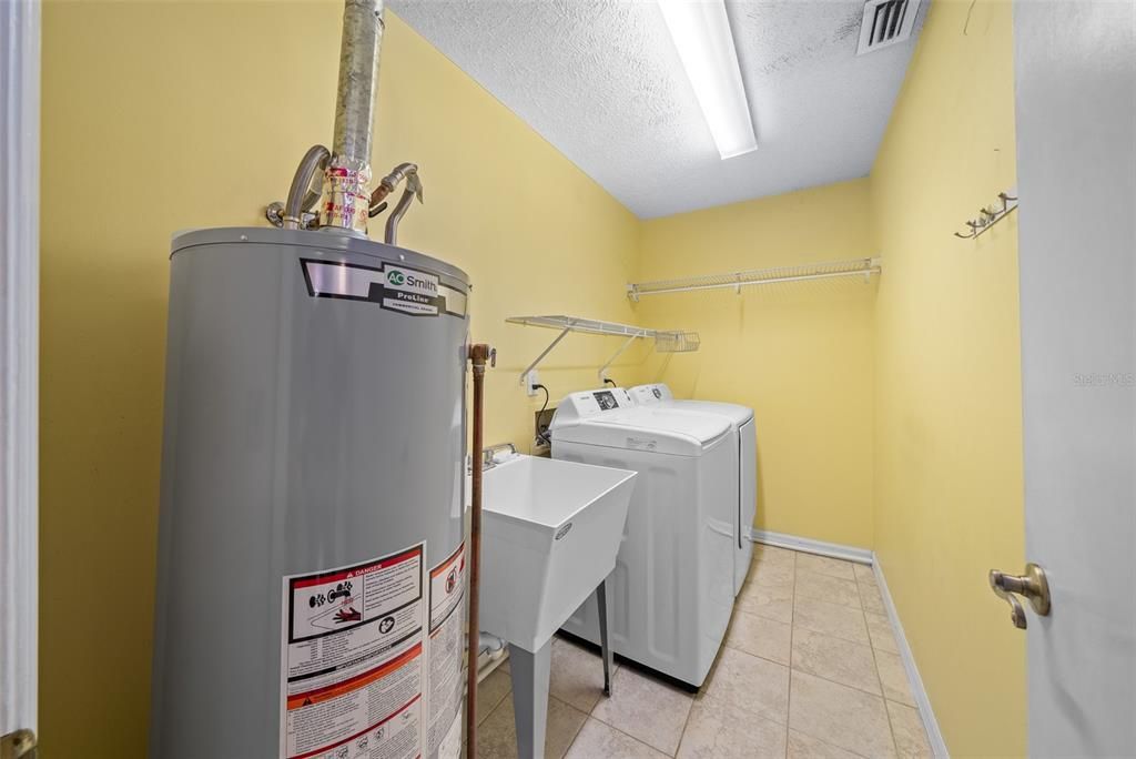 Indoor Laundry Room with Utility Sink and Gas Water Heater