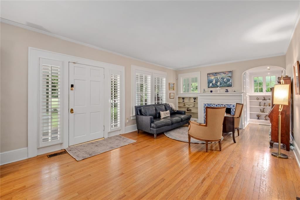 Trim work in the formal living room with vintage blue tile surrounded fireplace