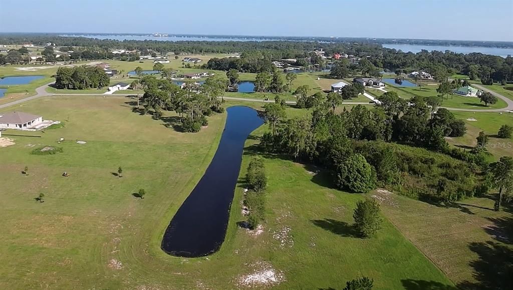 View looking from rear of lot. Lot runs parallel to pond along right shoreline.