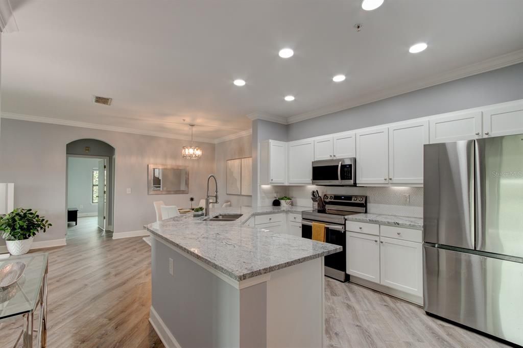 Solid Surface/Granite with Shaker Cabinets and recessed lighting