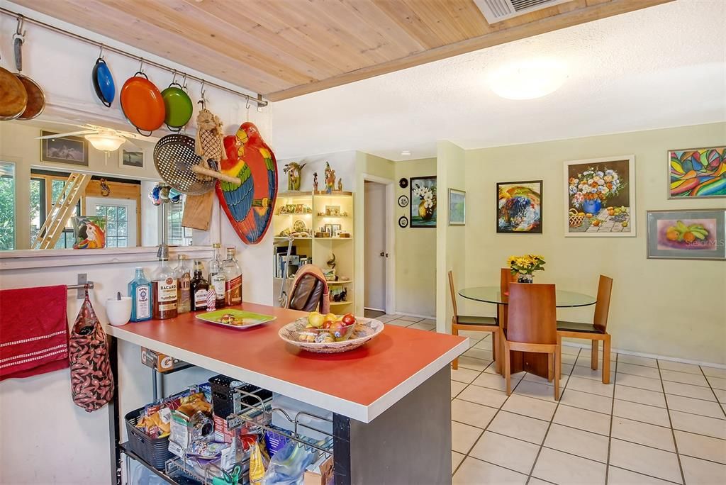 This picture shows the pass-through, the ladder leading up to the child's loft and to the left of the dining area is the door to the primary bathroom...