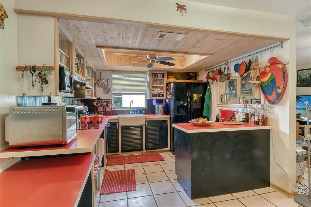 The kitchen is light and airy with a ceiling fan to keep it cool...