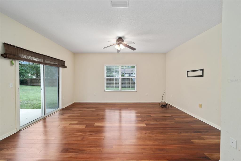 LARGE FAMILY ROOM WITH NEWER WOOD FLOORS