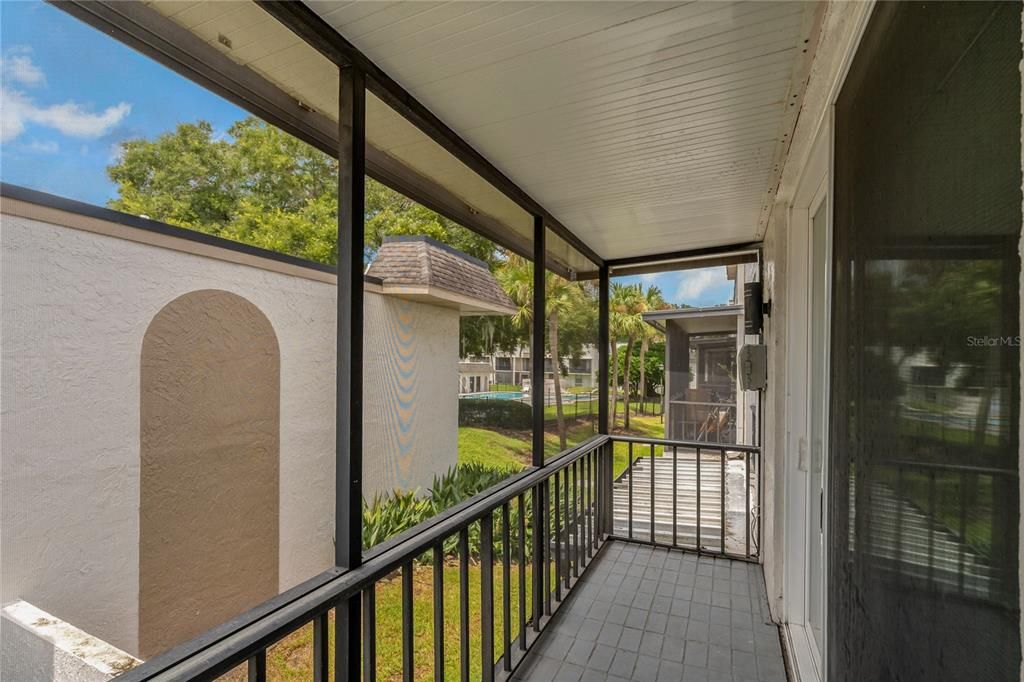 Screened Balcony with a view of one community pool