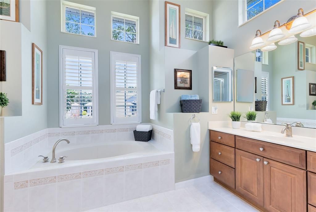 Master bathroom with tinted Transom windows, Soak Tub and two vanities.