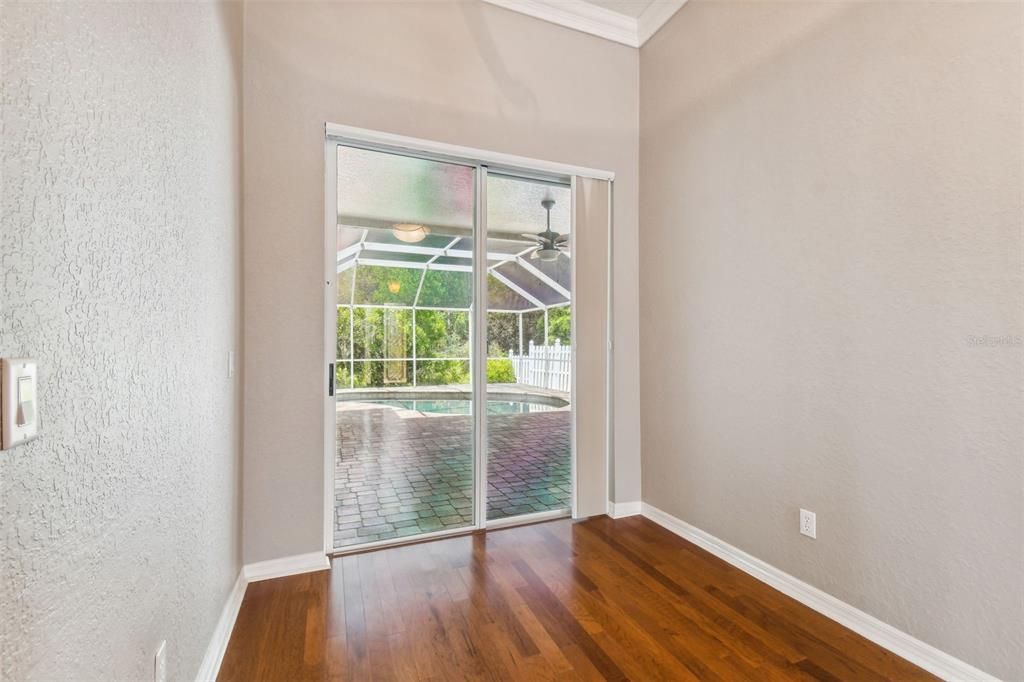 Living Room with Sliders to the pool and covered Patio