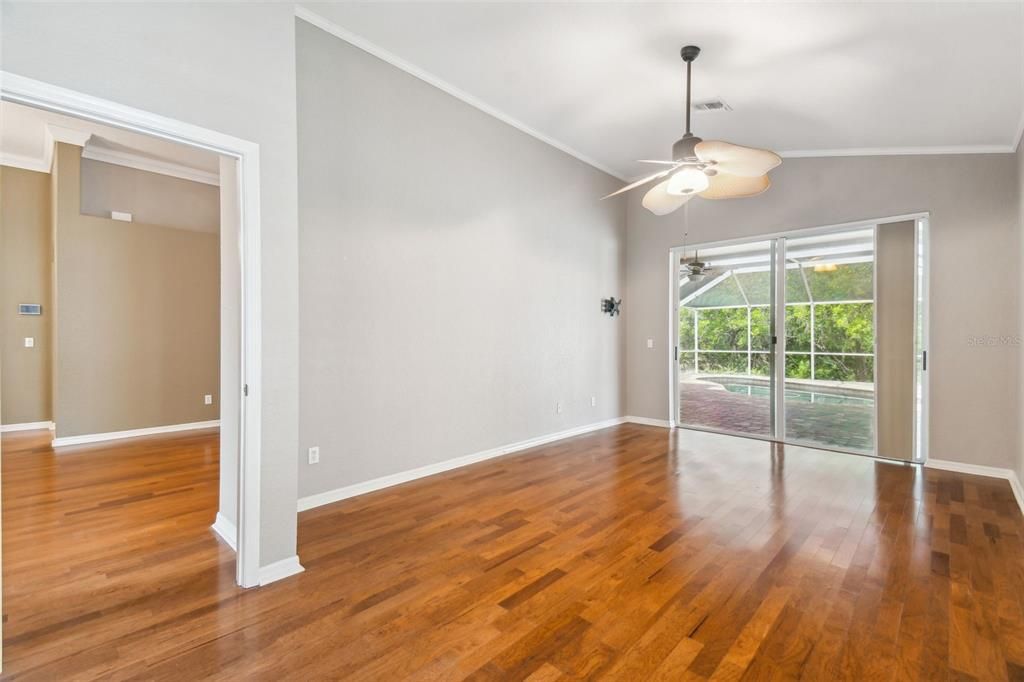 Oversized primary suite with sliders to the pool and covered patio