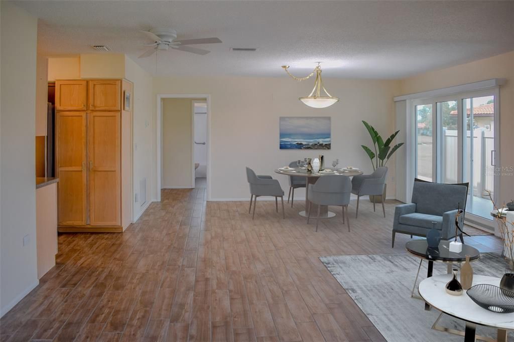 Virtually staged!  Extra large great room was remodeled and opened up making it larger than before. New oversized hurricane impact sliding doors installed.