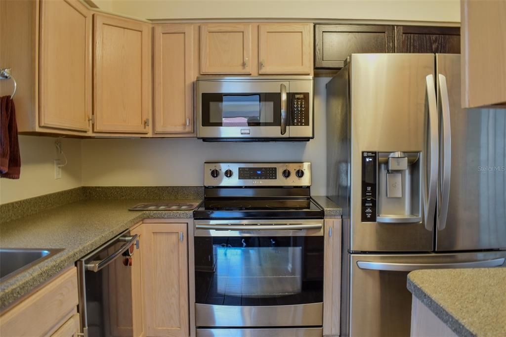 The kitchen has lots of cabinets.  Newer stainless steel appliances including dishwasher, refrigerator, stove and microwave.