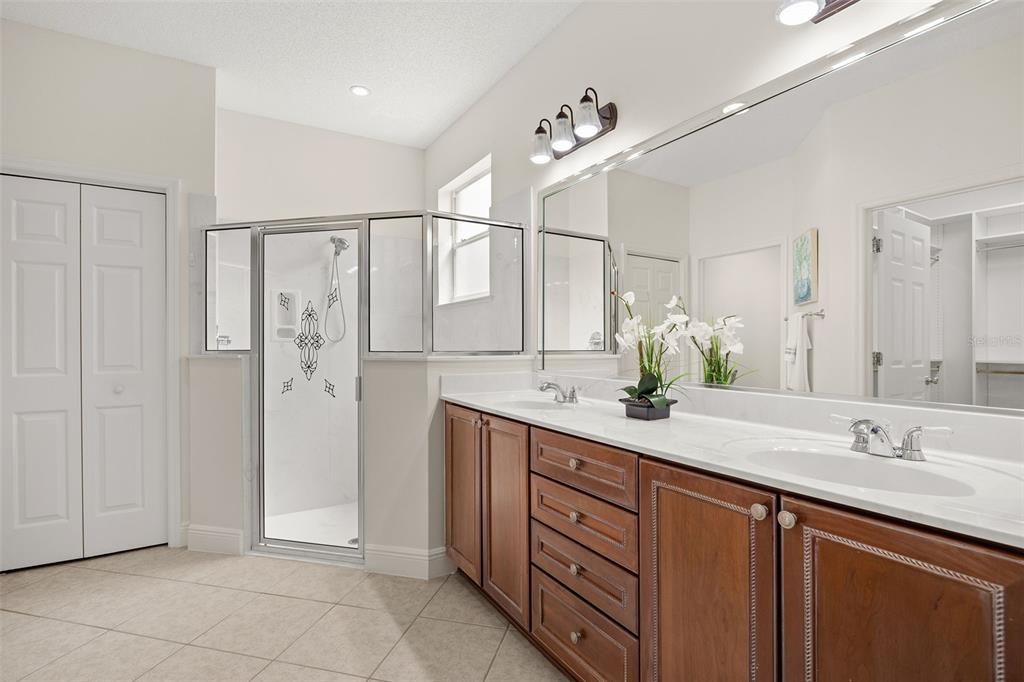 The en-suite master bathroom offers dual vanities, a walk-in shower, and a private water closet for your convenience.