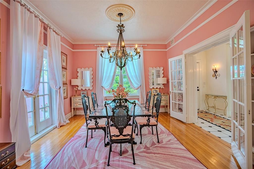 Formal Dining Room with built in cabinets and French doors to hallway