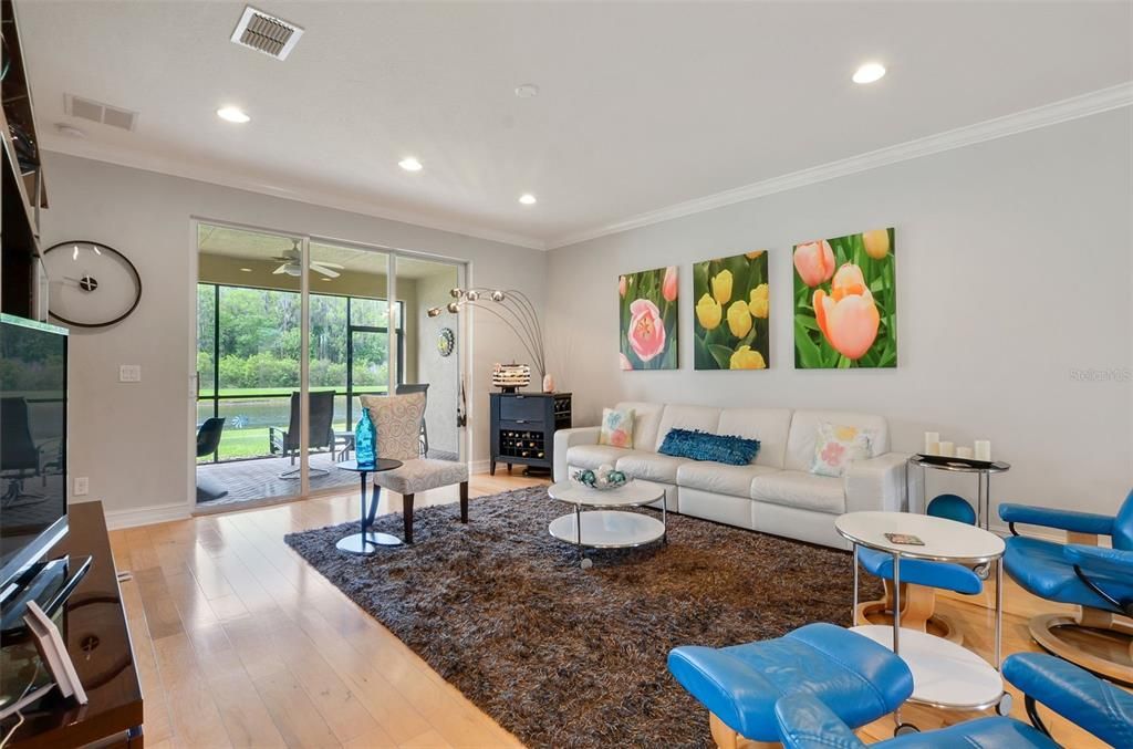 LIVING ROOM WITH SLIDERS TO LANAI & LAKE VIEW. SHOWN WITH PREVIOUS TENANT FURNISHINGS.