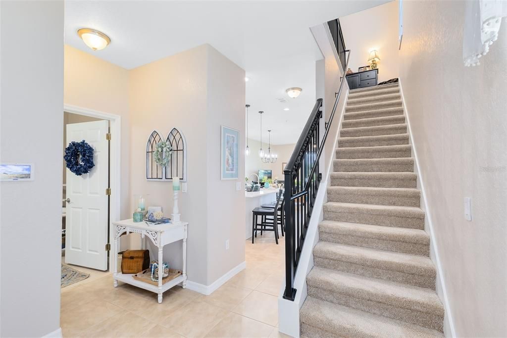 Step inside and be greeted by the soaring staircase and cozy foyer.