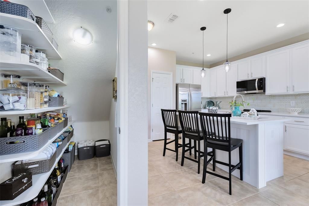 A large walk-in pantry provides abundant space for all your culinary needs.