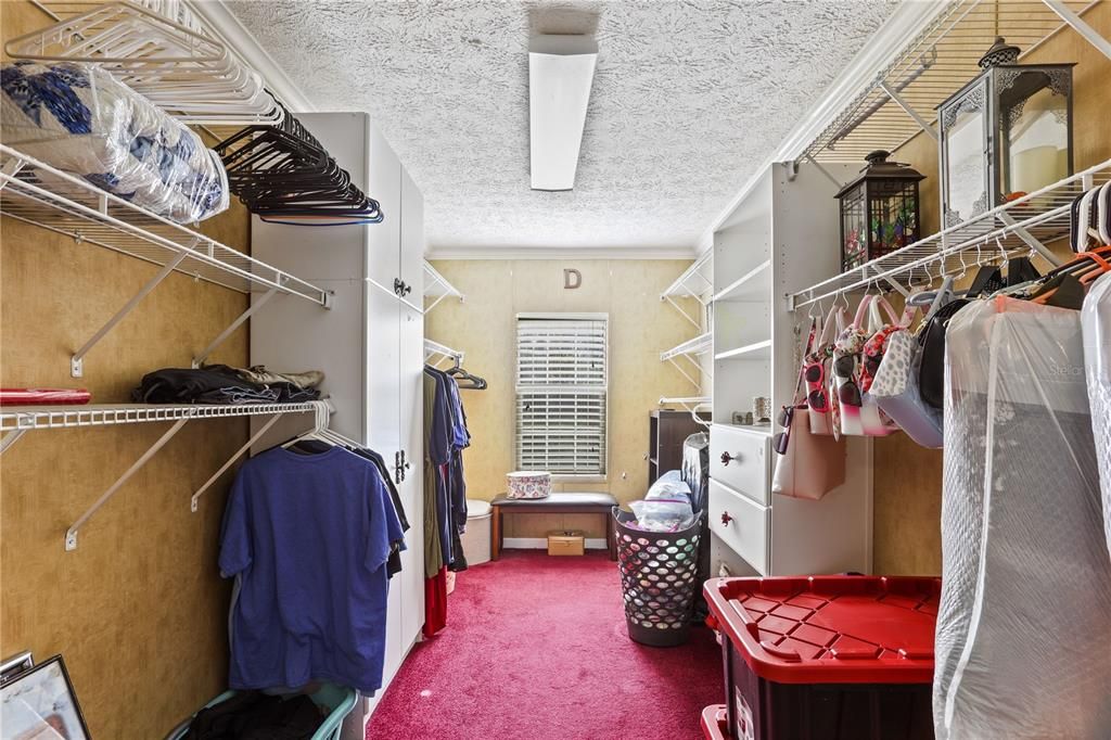 Primary bedroom walk in closet