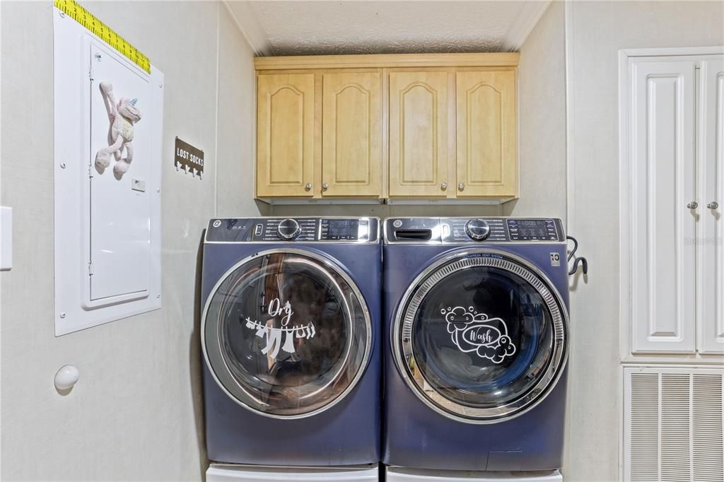 Laundry room with a utility sink and storage space!