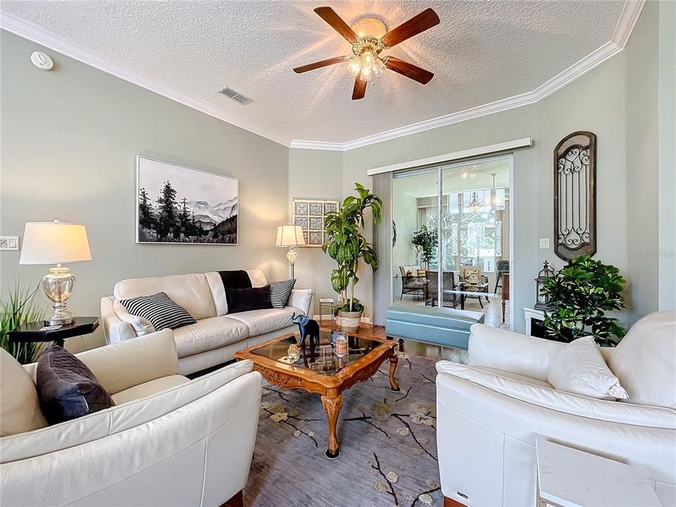 Living Room- Sliders lead out to enclosed lanai.