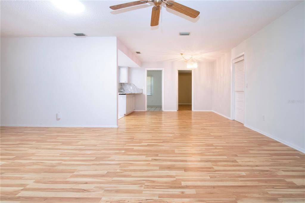 livingroom dining room breakfast bar. to the right is garage door strigh and right owners suite left door leads to enclosed lanai under air