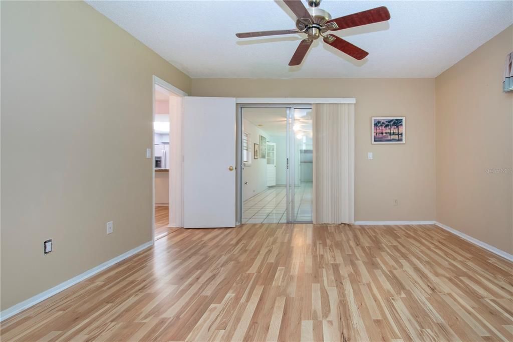 owners suite with sliding doors to the enclosed lanai