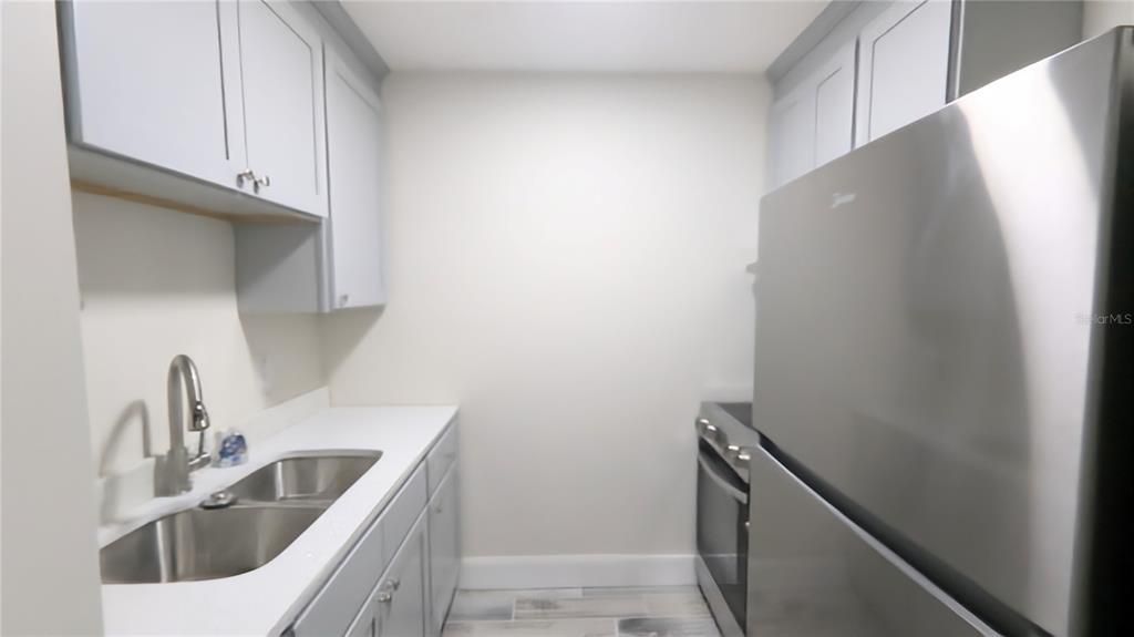 Kitchen with tile flooring and new cabinets