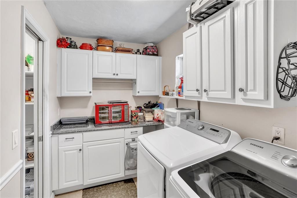 Utility room with storage space, washer and dryer