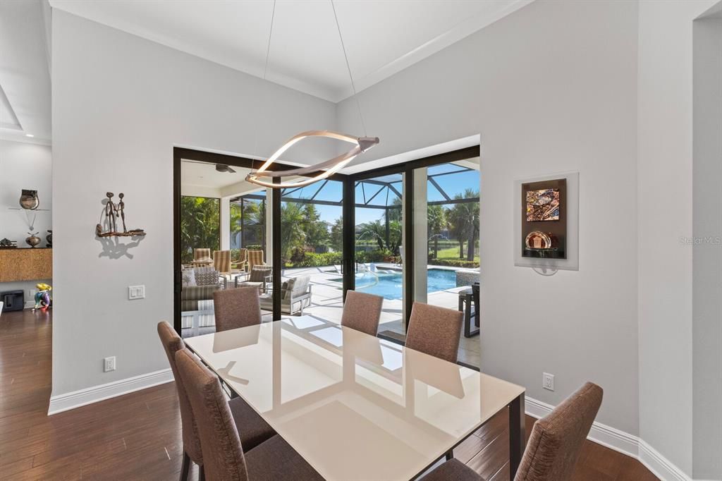 View from dining area to the fabulous outdoor living space. Notice the contemporary lighting touches.