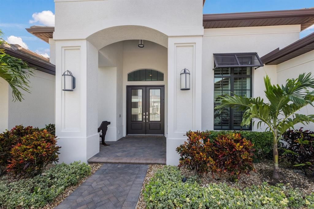 A welcoming entry with glass double doors