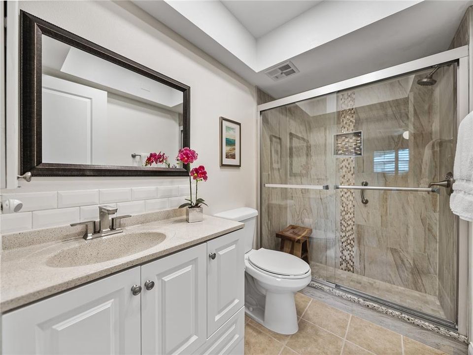 Updated en-suite with step-in shower, large vanity and updated lighting~