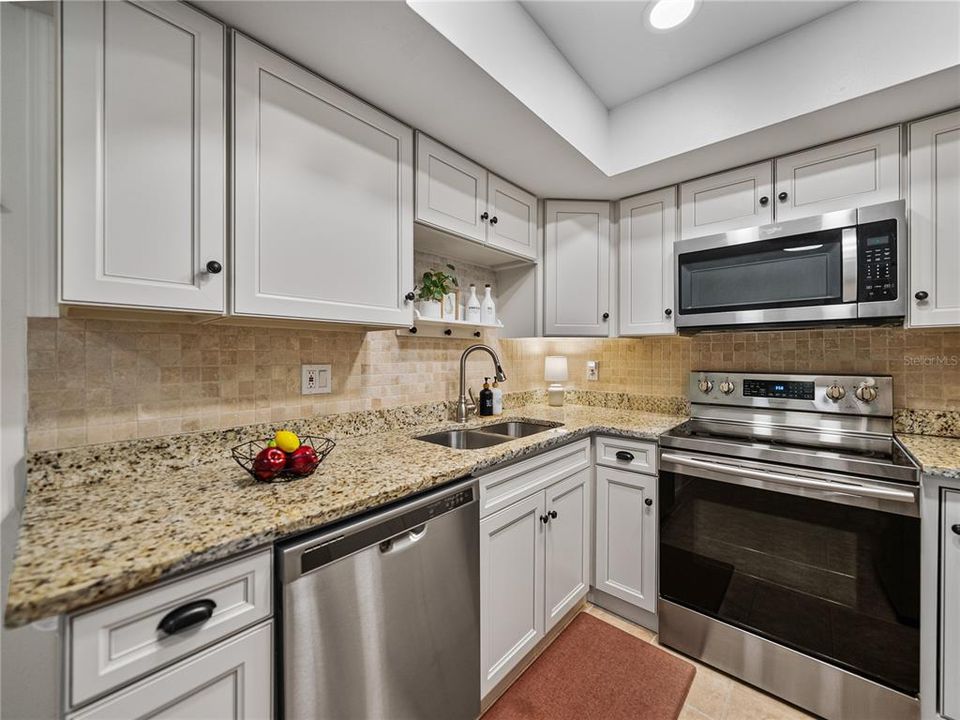 Granite countertops, newer solid wood cabinets, and newer kitchen appliances~