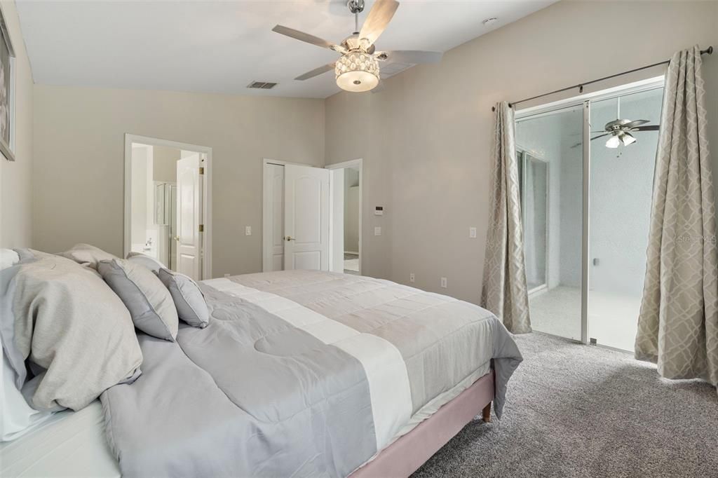 Primary Bedroom with Sliders Leading to Covered Patio Area